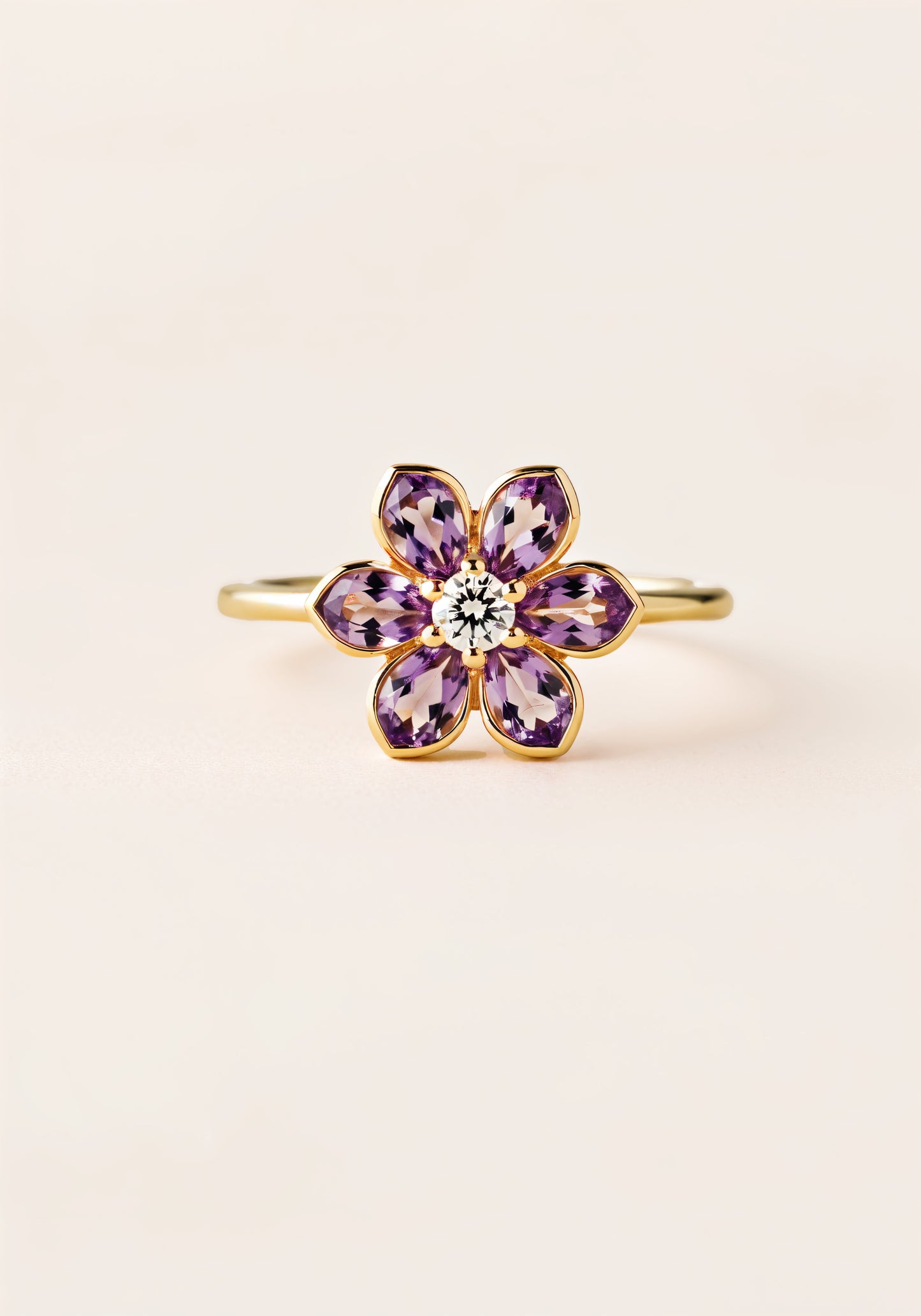 A gold ring with a six-petaled amathyst flower, with a white diamond in thecenter.