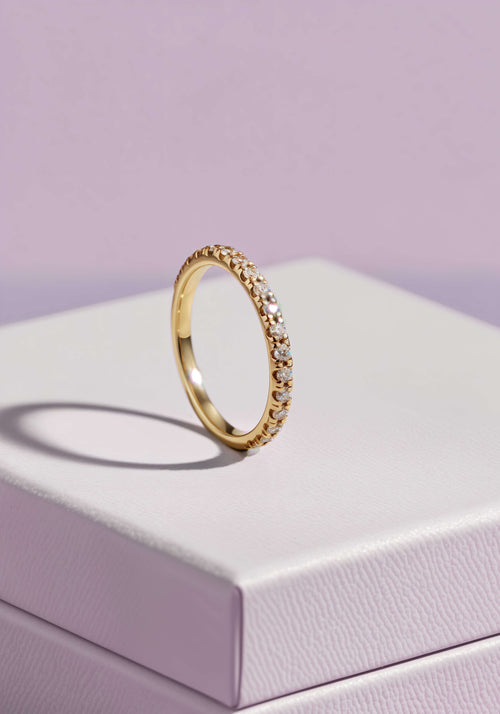 Load image 1 in gallery view. A diamong encrusted gold ring on a white jewelry box.