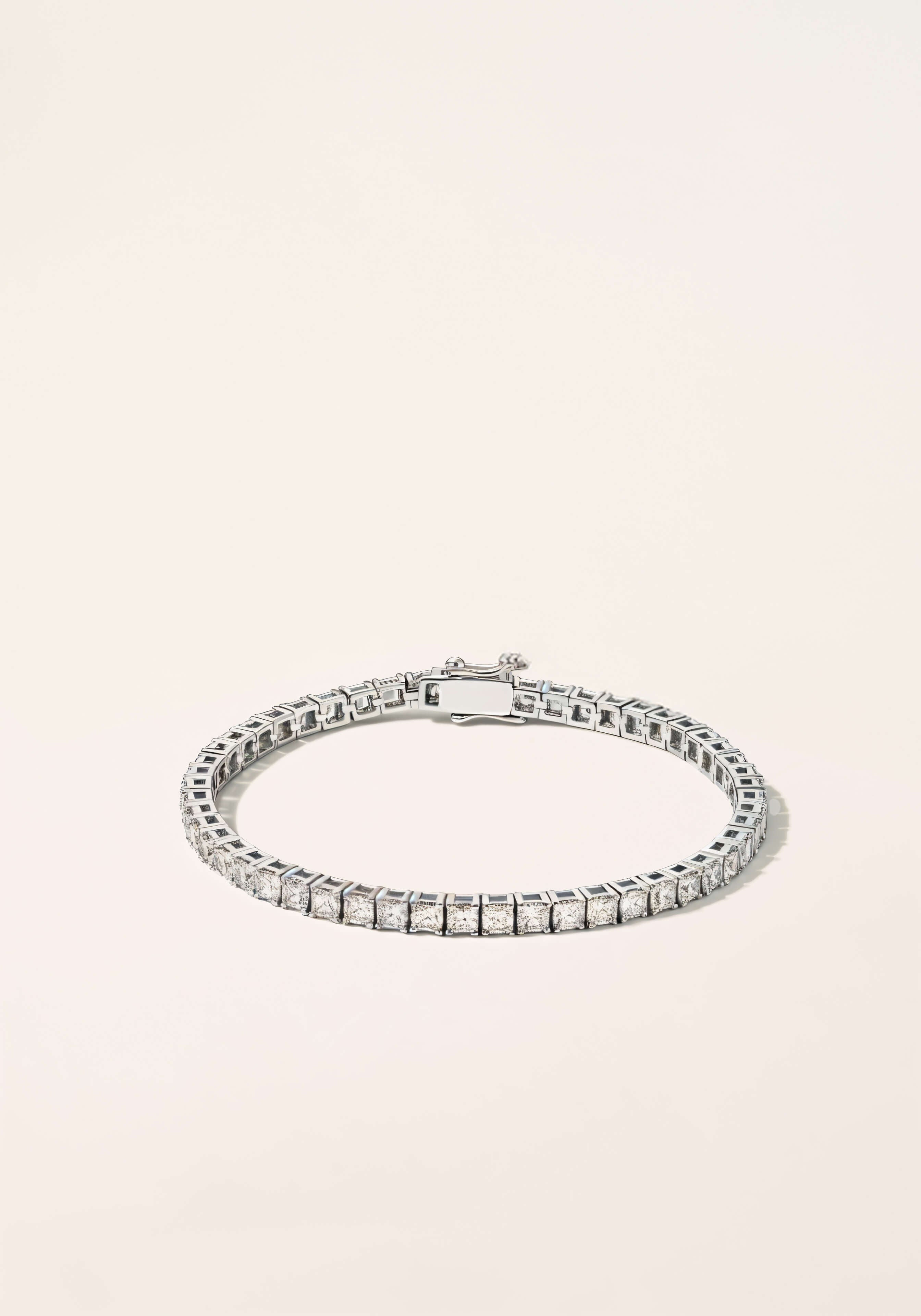 A white-gold tennis bracelet, a continuous strand diamonds set in square links.