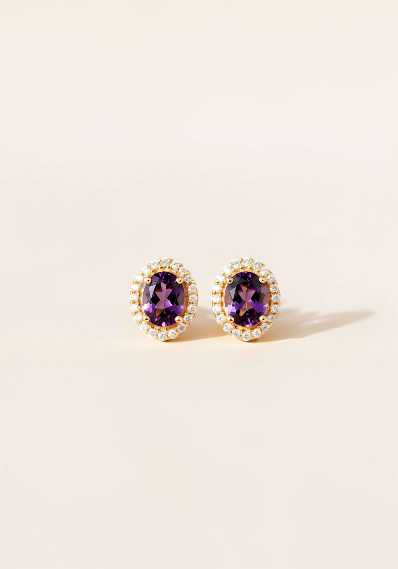 Amethyst earrings with a diamong halo set in gold.